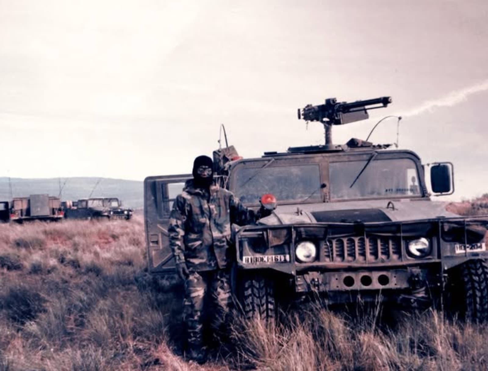 Standing by the Humvee in the field